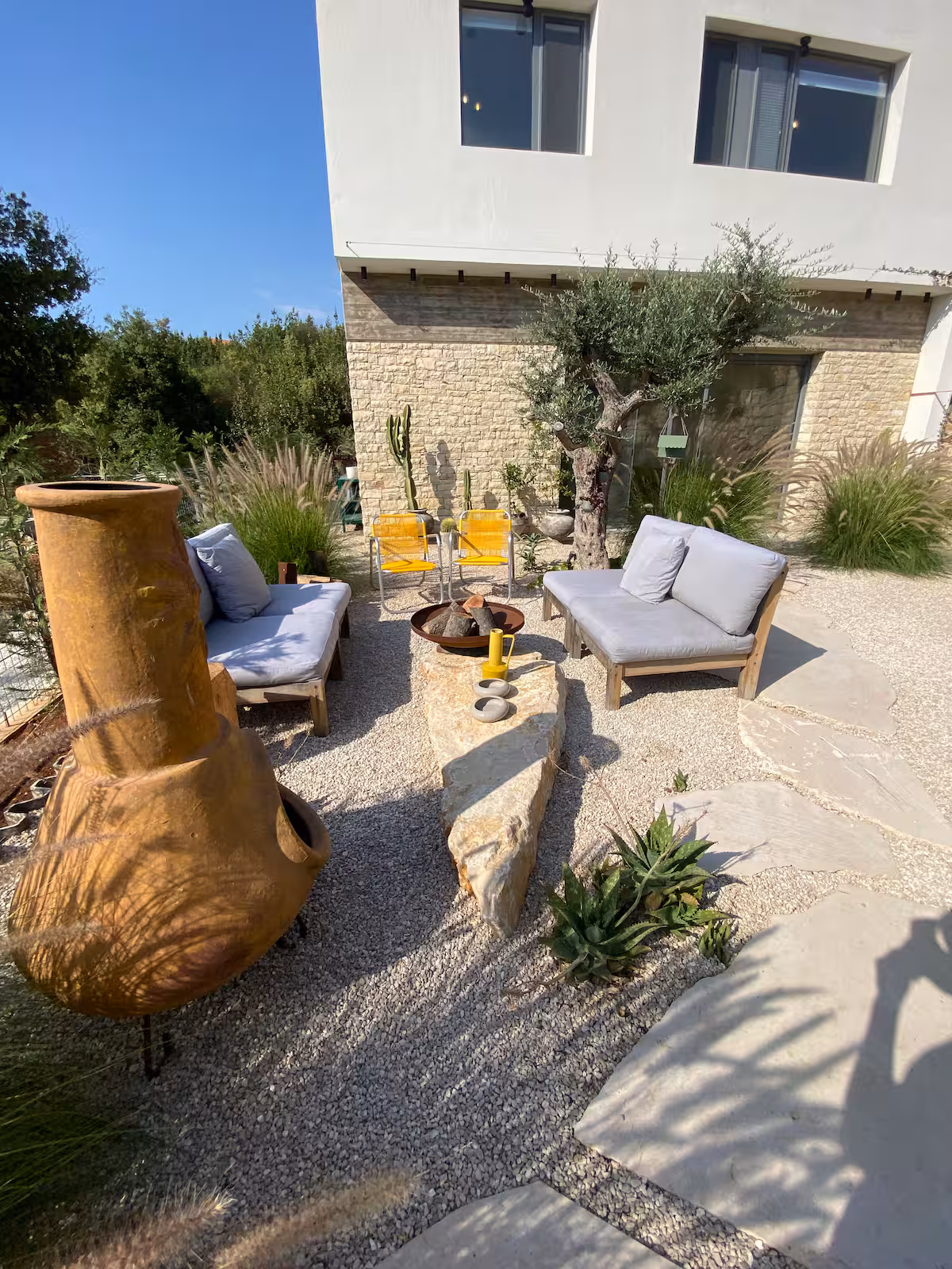 Fireplace Lounge at SOWK Guesthouse — A warm and simple space with a stone fireplace and soft seating—made for quiet evenings, shared stories, and moments of stillness at SOWK Guesthouse.