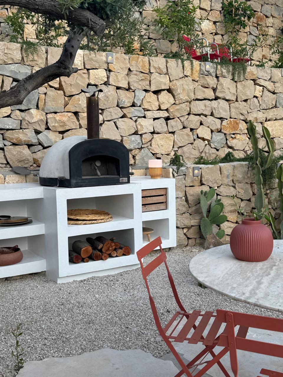Artisan Pizza Terrace at SOWK Guesthouse — A handcrafted wood-fire oven set against ancient Lebanese stone walls—where Mediterranean ingredients meet centuries-old culinary traditions under the open sky.