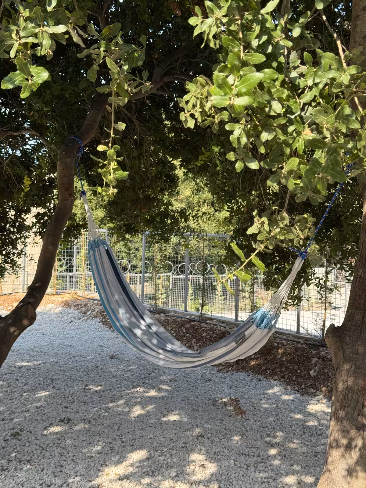 The Hammock Terrace at SOWK Guesthouse — A breezy terrace designed for laid-back moments—featuring a dining table for sunset meals, two cozy hammocks, and a playful baby foot corner, all overlooking the hills of Smar Jbeil.
