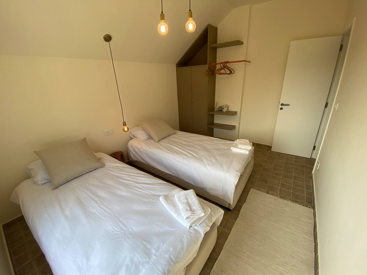 Twin Room at SOWK Guesthouse — Quiet and simple, this twin room offers two single beds, soft lighting, and a clean, uncluttered design—made for slow mornings and easy rest at SOWK Guesthouse.